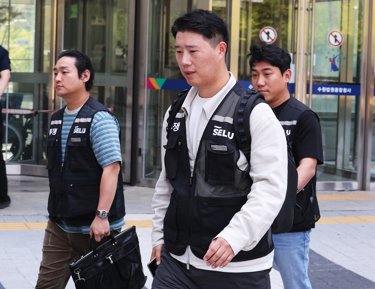 Choi Seung-ho (C), head of Samsung Electronics Co.'s largest labor union, leaves the Suwon District Court in Suwon, south of Seoul, on Wednesday, after attending a hearing on the company's request for an injunction against a strike. (Yonhap)
