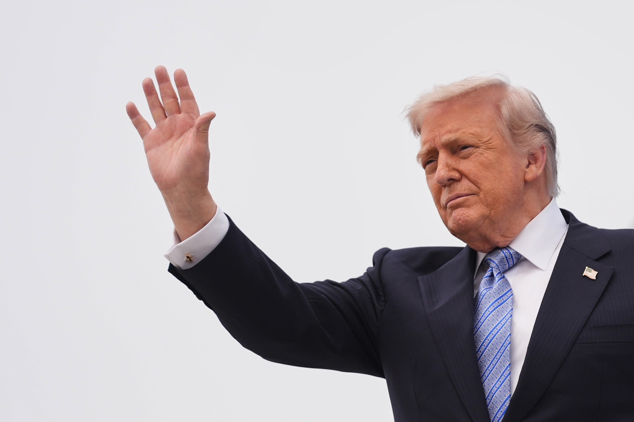 US President Donald Trump waves as he boards Air Force One on Friday at Beijing Capital International Airport in Beijing. (AP-Yonhap)