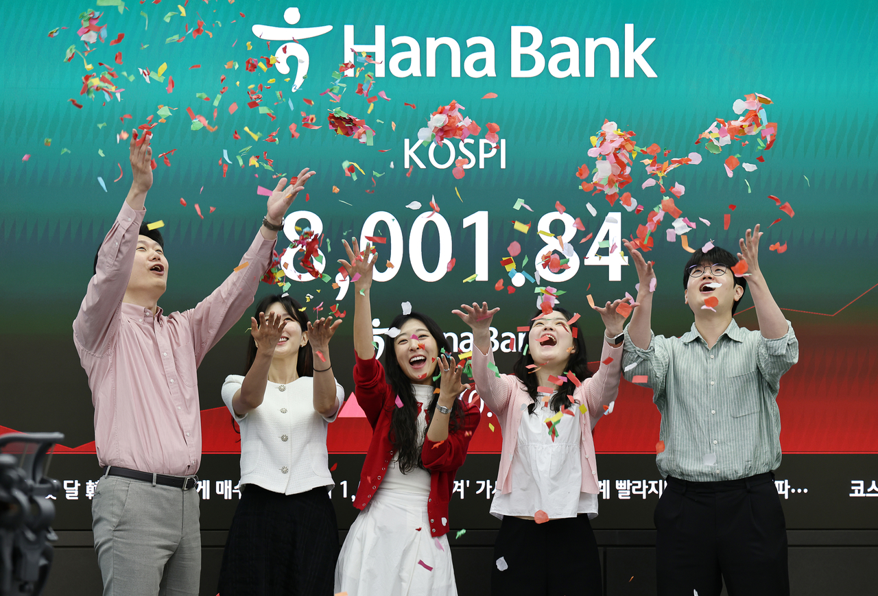 Hana Bank dealers celebrate the Kospi's 8,000 feat in Seoul on Friday morning. (Yonhap)