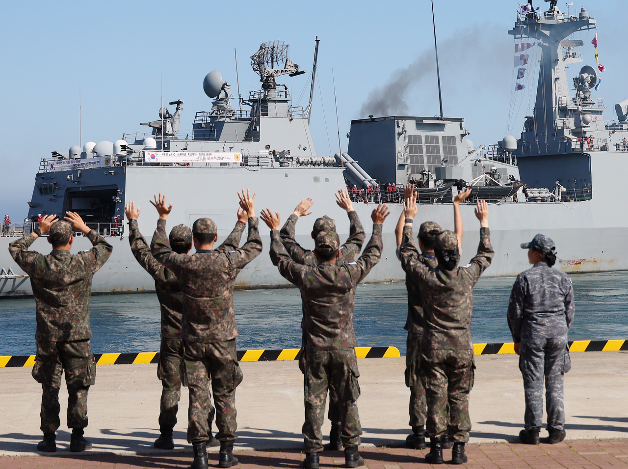 The  Wang Geon destroyer sets sail, receiving a farewell from the troops during the departure ceremony at a naval base in Busan on Friday. (Yonhap)