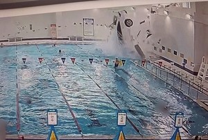 Car crashes into pool at sports center, swimmers rescue driver