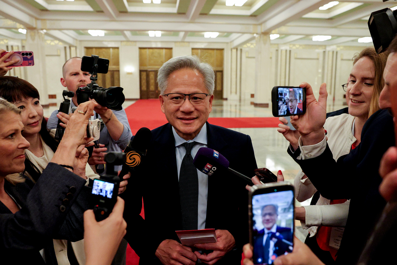 Nvidia CEO Jensen Huang speaks to the media during a meeting with Chinese Premier Li Qiang and US business representatives in Beijing, amidst discussions on semiconductor trade and AI chip technology. (AP-)