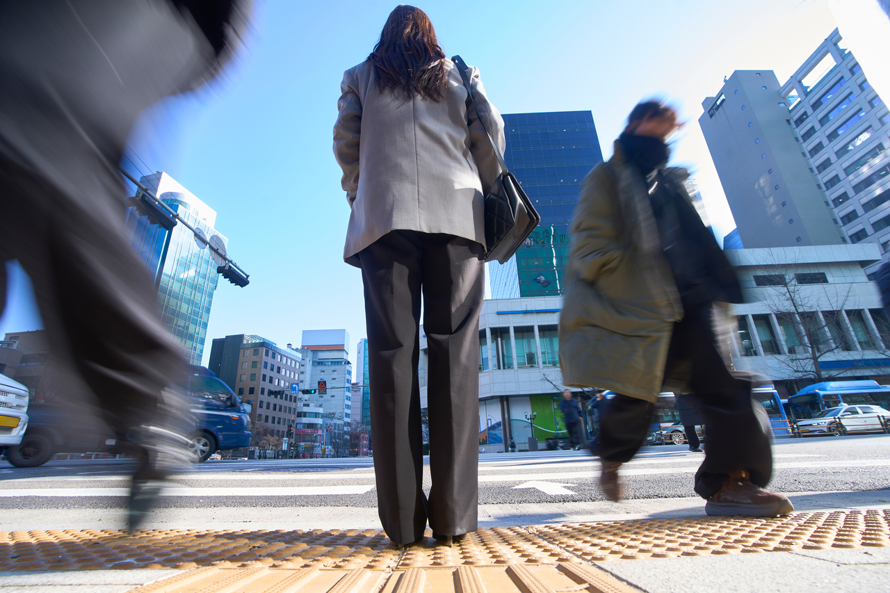 Commuters on a street. (Getty Images Bank)