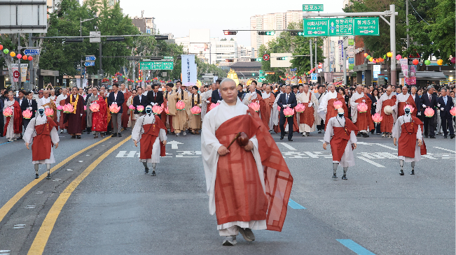 Four robot monks — Gabi, Seokja, Mohui and Nisa — follow a human monk in the lantern parade in Jongno, Seoul, Saturday. (Newsis)