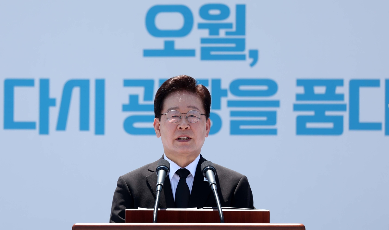 President Lee Jae Myung addresses an annual ceremony at a plaza in front of the former South Jeolla provincial government building in Gwangju on Monday, to mark the 46th anniversary of a 1980 pro-democracy uprising. (Pool photo via Yonhap)