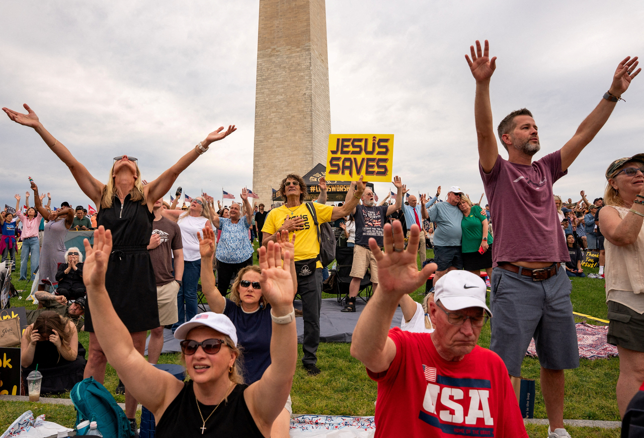 People worship near the Washington Monument during a prayer rally ahead of the “Rededicate 250: National Jubilee of Prayer, Praise and Thanksgiving” event in Washington, Saturday.   (Reuters-Yonhap)