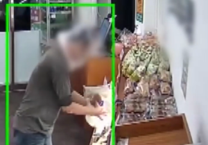 Surveillance footage captures man wearing plastic bag stealing from unstaffed bakery