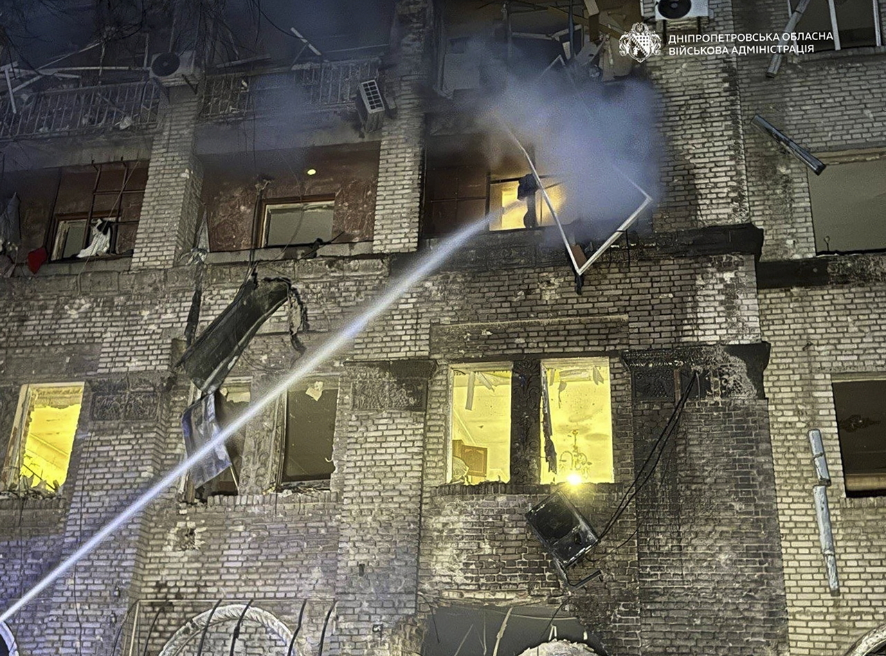 Ukrainian rescuers work at the site of a Russian strike Dnipro, Ukraine, Monday. (EPA-Yonhap)