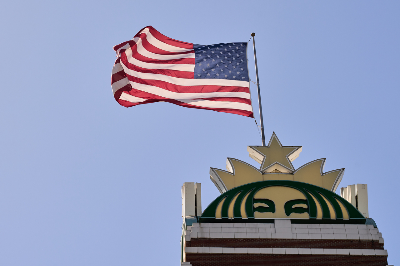 A United States flag waves on top of the Starbucks global headquarters building in Seattle on May 11 (AP-Yonhap)
