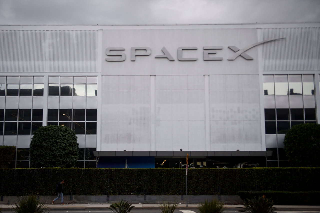A pedestrian walks past the Space Exploration Technologies Corp. (SpaceX) headquarters in Hawthorne, California. (AFP)