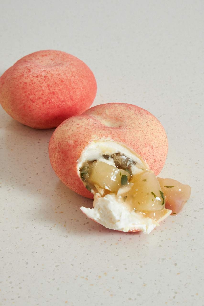 Fruit-shaped Korean mousse cake with glossy chocolate shell in the sensory dessert trend that drives Cooking Tree style ASMR videos