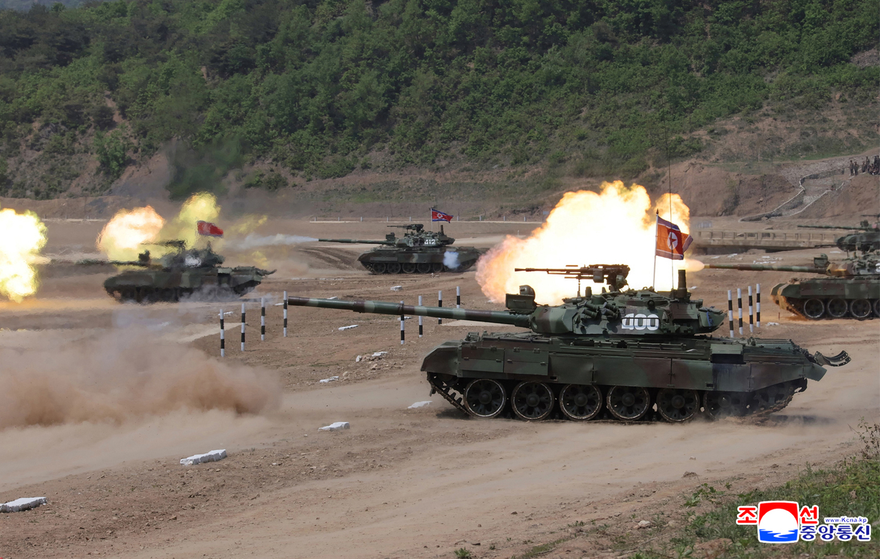 North Korean tanks fire shots during tactical drill demonstrations of different arms under the training course of the conference of training officers at a boot camp of the North Korean army's Capital City Defence Corps on May 13, 2025, in this photo released by the North's official Korean Central News Agency the next day. The North's leader Kim Jong-un watched the drill demonstrations, stressing that the most "crucial" task for the North's armed forces is to make full preparations for war. (Yonhap)