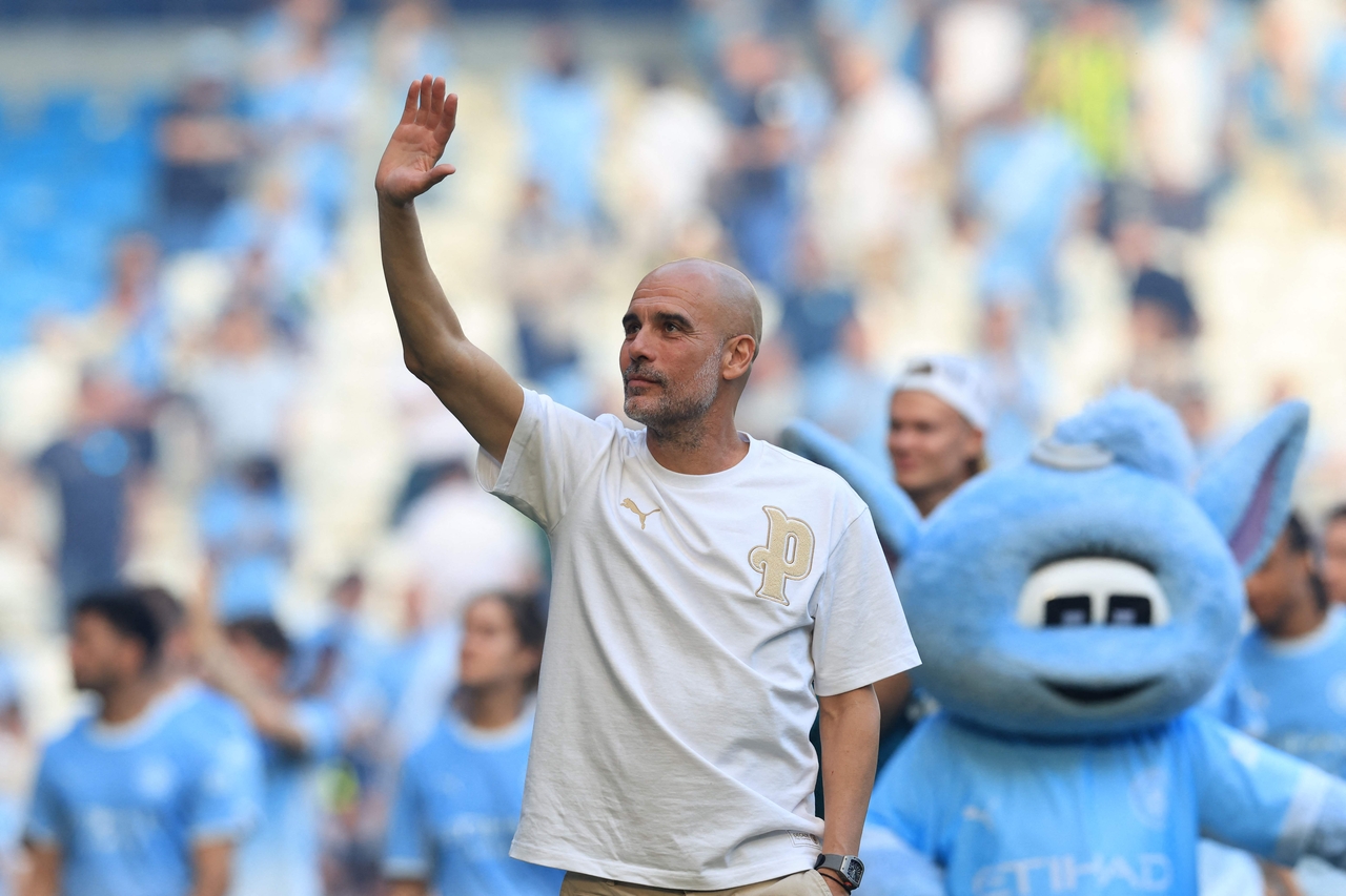 Manchester City's manager Pep Guardiola waves as he takes a lap of honor at the Etihad Stadium in Manchester, England, Sunday.   (AFP-Yonhap)