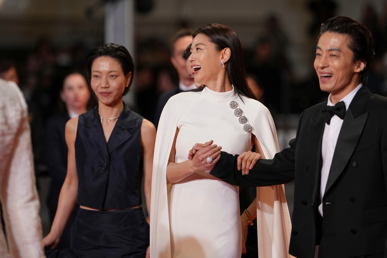From left: Kim Shin-rok, Jun Ji-hyun and Koo Kyo-hwan pose for photographers upon arrival at the "Colony" premiere at the 79th international film festival in Cannes, southern France, on Friday, May 15. (AP Photo/Andreea Alexandru)