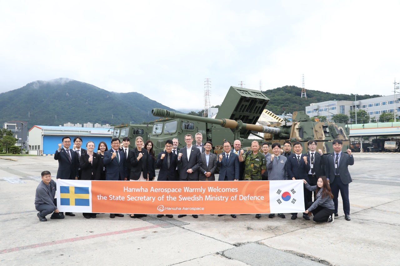 Peter Sandwall (center), Sweden's state secretary to the minister for defense, Swedish defense officials and Hanwha Aerospace executives pose for a photo in front of the K9 self-propelled howitzer during a visit to Hanwha Aerospace’s Changwon plant on Wednesday. (Hanwha Aerospace)