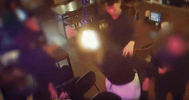 Officer Park Ji-hoon (right) restrains a man wielding a broken bottle at a restaurant in Daegu on April 10. (KNPA)