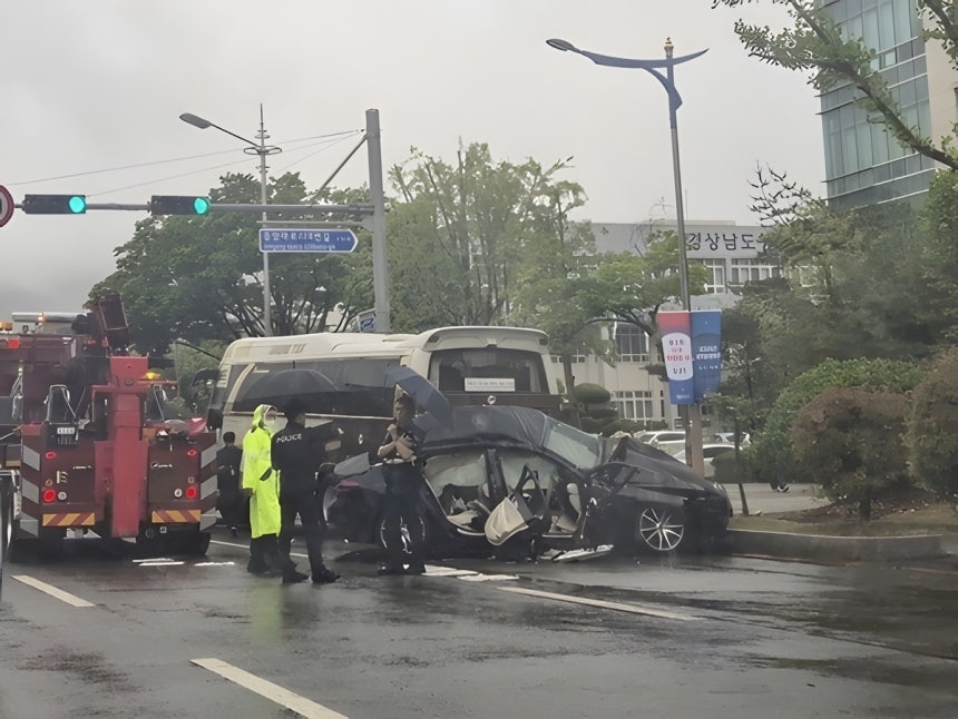 This photo provided by the Changwon Metropolitan Fire Headquarter shows police officials investigating the site of a fatal car crash in Changwon, South Gyeongsang Province, Wednesday. (Yonhap)