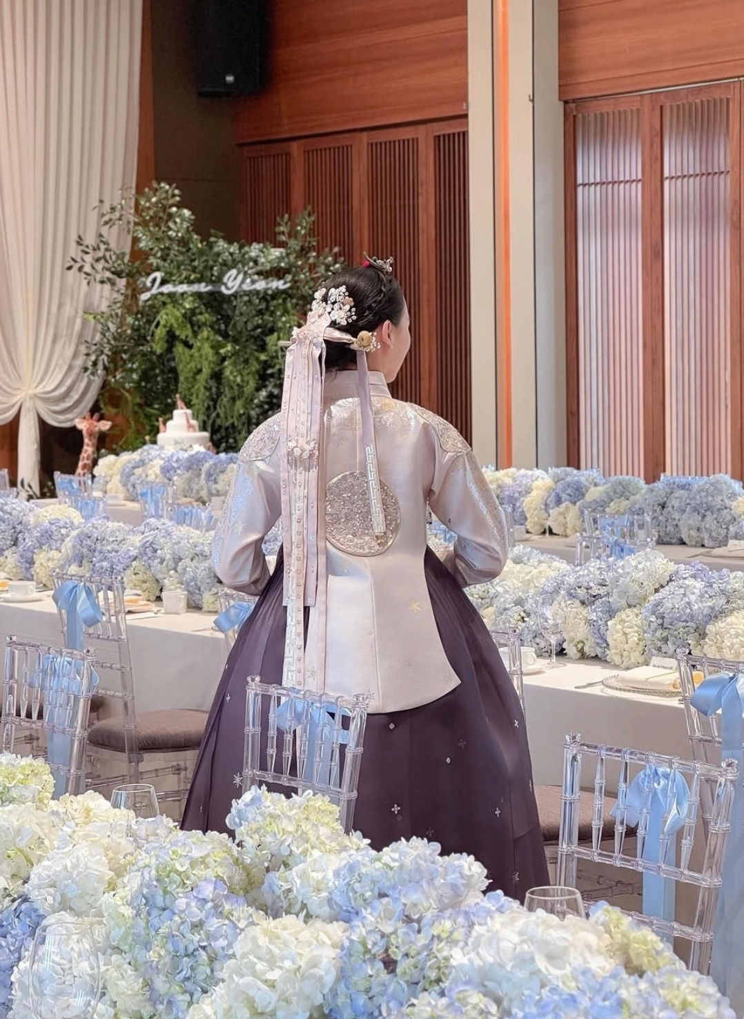 Former rhythmic gymnast Son Yeon-jae attends her son’s doljanchi in 2025 wearing a ceremonial hanbok featuring a flowing "galrae chima" silhouette. (Son Yeon-jae’s Instagram)