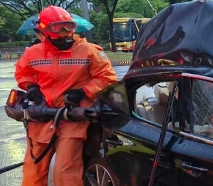 This photo provided by the Changwon Metropolitan Fire Headquarter shows the car that crashed into a parked bus on Wednesday, killing the driver and both passengers. (Yonhap)