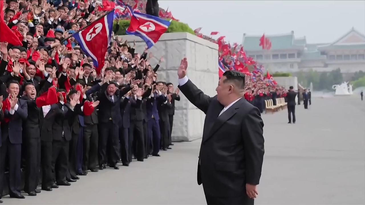 This file image, captured from footage of a North Korean state-run TV station on May 3, shows the North's leader Kim Jong-un meeting with participants of the 11th congress of the Socialist Patriotic Youth League the previous day. (Yonhap)