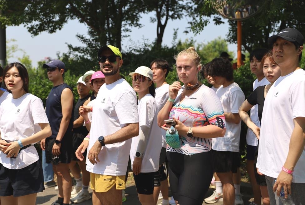 Participants gather at Han River Park in Seoul for a noncompetitive triathlon festival, showing Korea's active urban riverside life