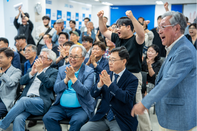 Liberal canddiate Jung Geun-sik (second from right) and his supporters cheer after learning of the exit poll results at his campaign office, in Jongno-gu, Seoul, Wednesday. (Jung Geun-sik's campagin office)