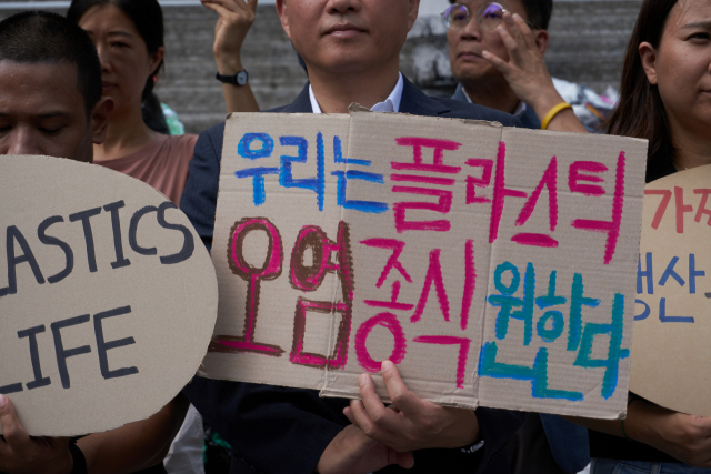 서울 종로구 세종문화회관에서 ‘플뿌리연대’가 정부의 강력한 플라스틱 규제 협약 참여와 국제협약 도출을 요구하는 퍼포먼스를 하고 있다. [플뿌리연대 제공]