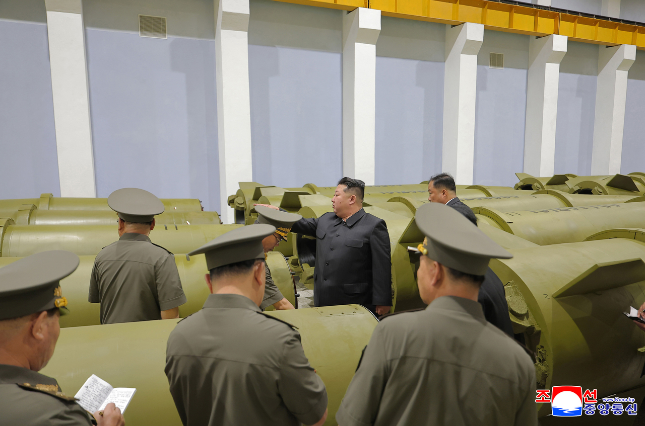 North Korean leader Kim Jong-un (center) inspects a major munitions industrial enterprise on Saturday to review the production of key weapons during the first half of 2026, the Korean Central News Agency reported the following day. (KCNA-Yonhap)