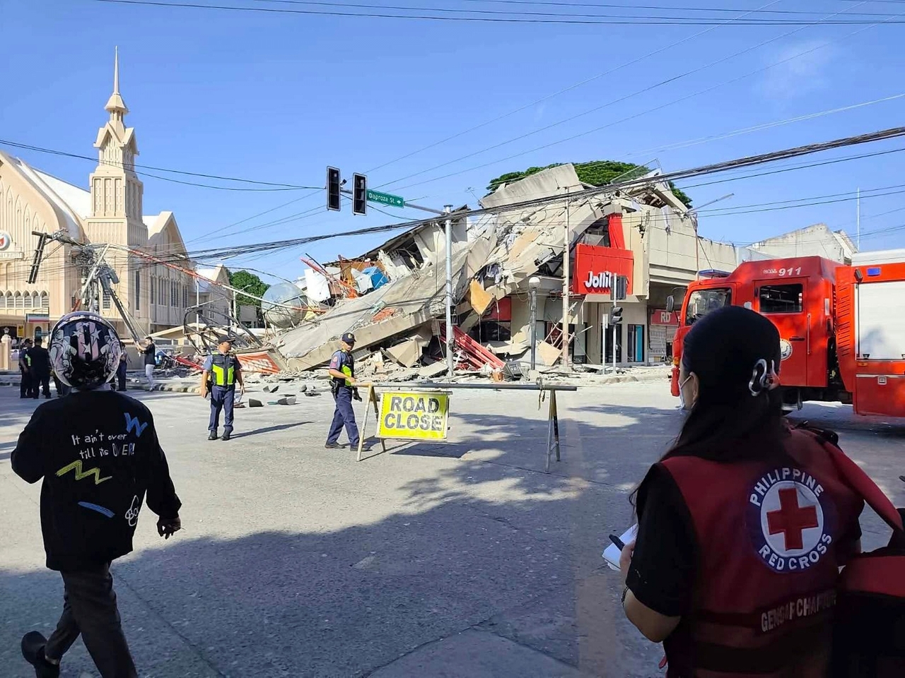 Rescuers inspect the damage after an earthquake in General Santos, Philippines, Monday. (Philippine Red Cross via AP)