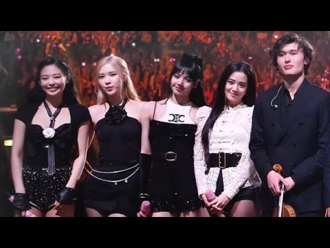 Blackpink and violinist Daniel Lozakovich (right) pose together at a televised charity gala hosted by French first lady Brigitte Macron in January 2023. (Daniel Lozakovich's YouTube)