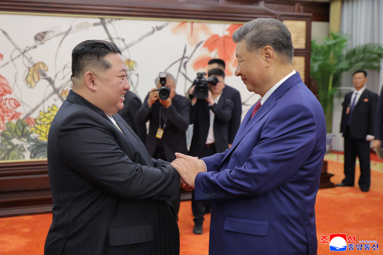 In this file photo uploaded Friday, Chinese President Xi Jinping (right) and North Korean leader Kim Jong-un shake hands ahead of their bilateral summit during Kim's visit to China on Sept. 4, 2025. China and North Korea announced Friday that Xi will pay a state visit to North Korea on Monday and Tuesday, marking his first trip to the country since June 2019 and his second since Kim took power. (KCNA-Yonhap)