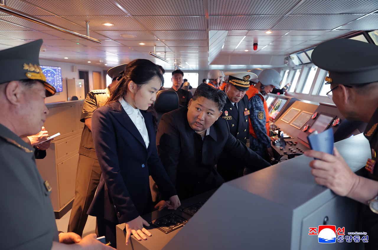 North Korean leader Kim Jong-un (center) accompanied by his daughter Kim Ju-ae, visits navy destroyer Kang Kon and observes its sea trials after it entered the operational capability evaluation phase, according to the Korean Central News Agency on Saturday. (KCNA-Yonhap)