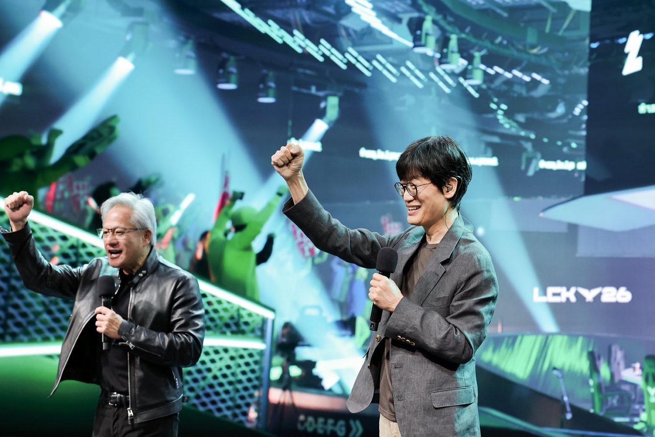 Nvidia CEO Jensen Huang (left) and Naver Chairman Lee Hae-jin pump their fists during a live stream on Naver's streaming service Chzzk at the firm's 1784 building in Seongnam on Monday. (Naver)