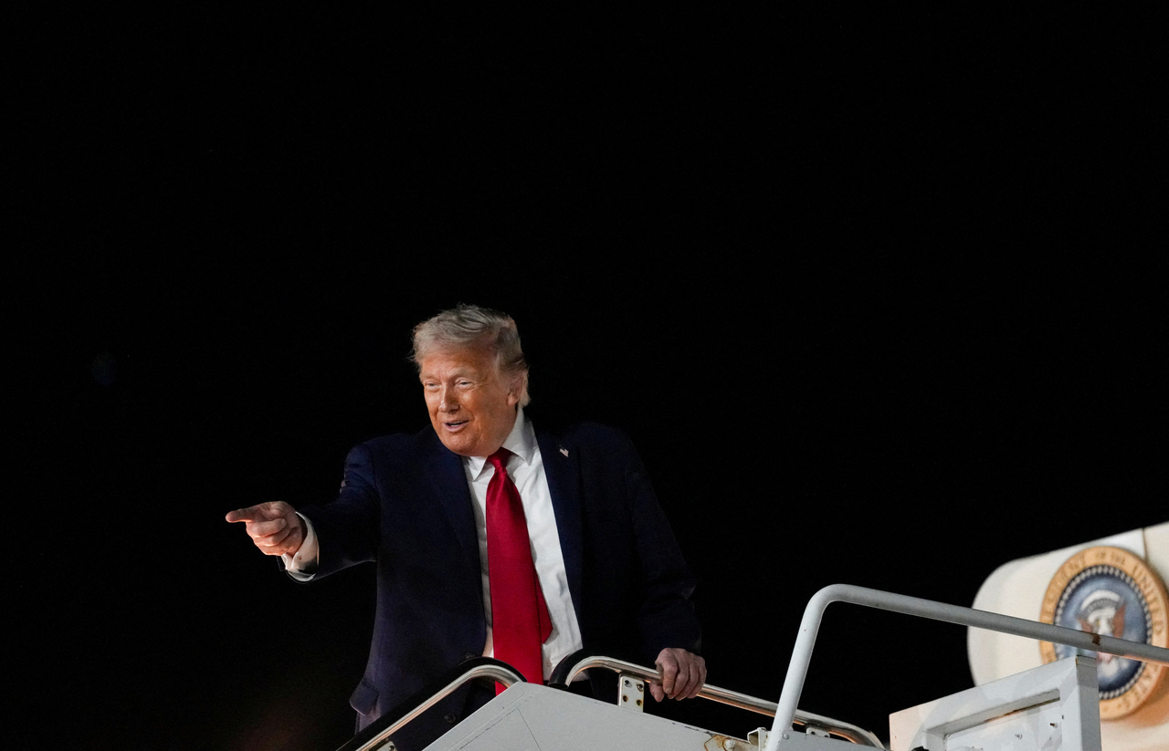 US President Donald Trump reacts as he boards Air Force One, after attending Game 3 of the NBA Finals, at John F. Kennedy International Airport in New York on Monday. (Nathan Howard/Reuters)