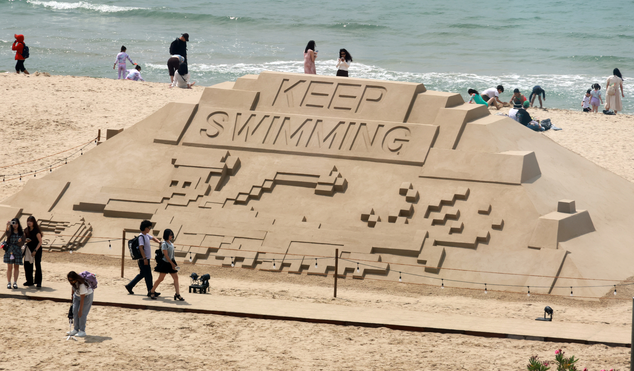 A sand sculpture promoting BTS' "Swim" is installed near Haeundae Beach on Tuesday. (Yonhap)