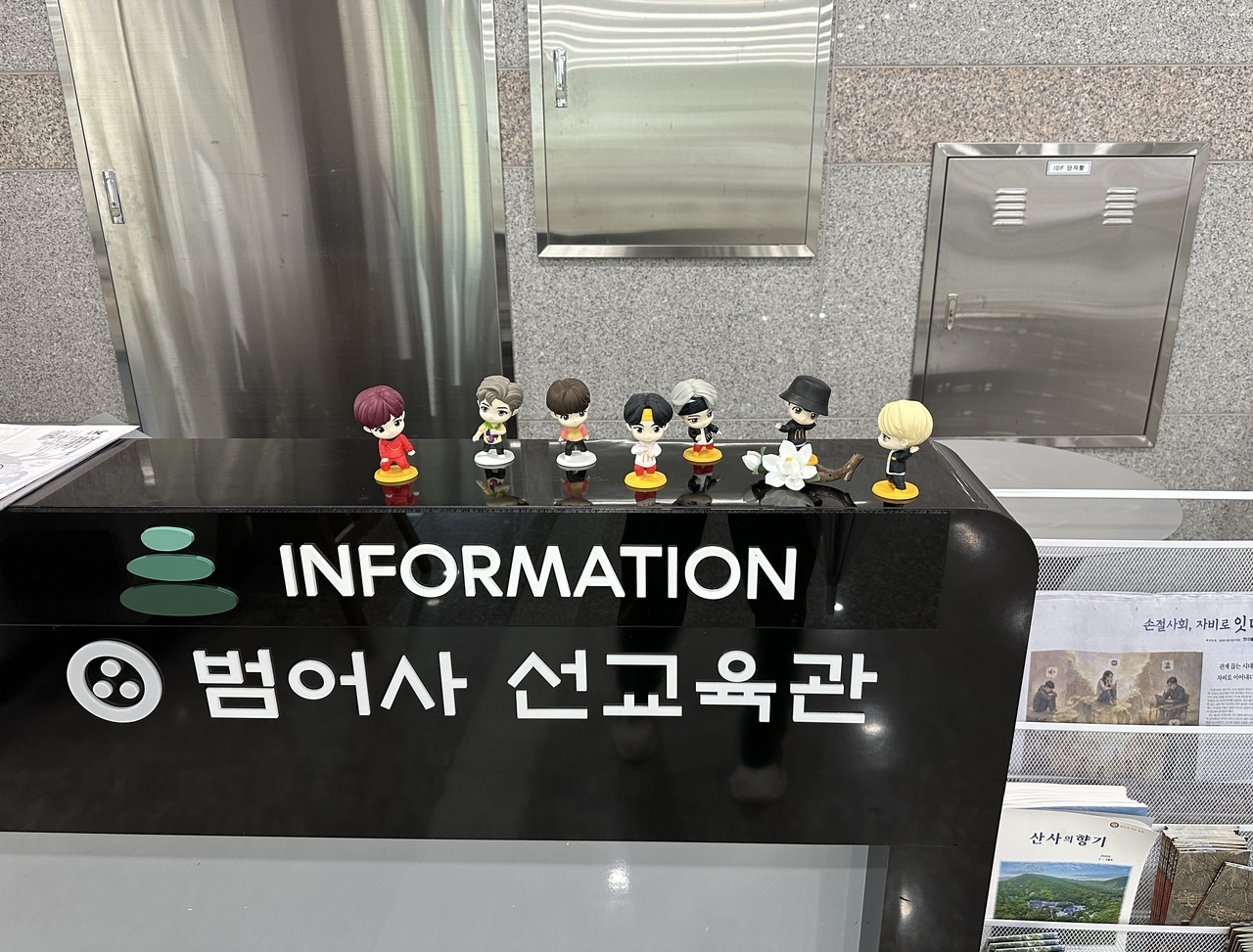 BTS figures are displayed at the information desk of Beomeosa's Seon Education Center, adjacent to the templestay accommodations, in Busan. (Tammy Park/The Korea Herald)