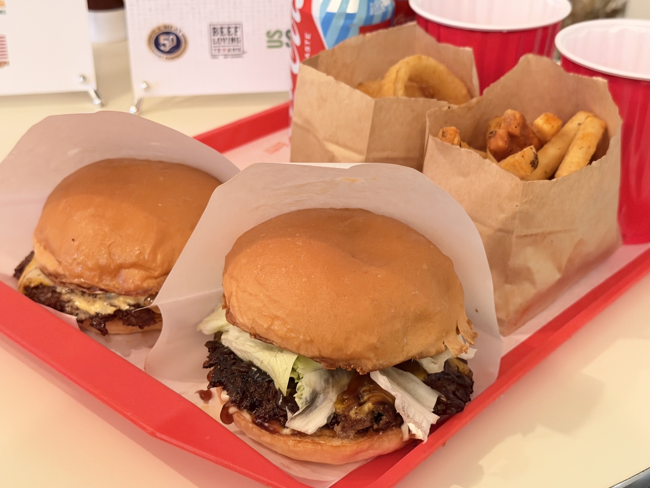 Snickers Burger Club's signature Snickers Cheese Burger (left) and Bulgogi Burger (right) (Hong Yoo/The Korea Herald)