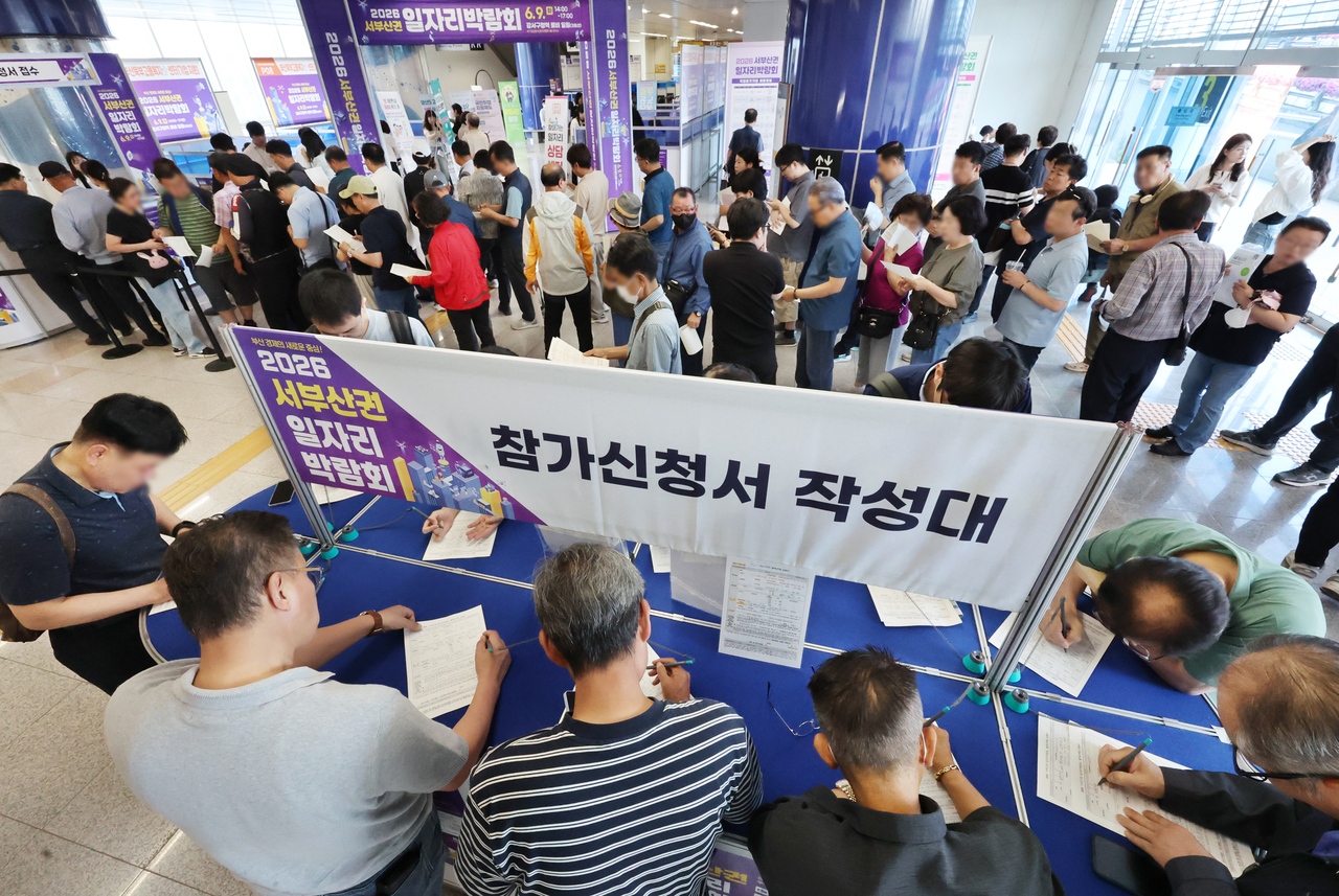 Visitors apply to participate in a job fair in the southeastern port city of Busan on June 9, 2026. (Yonhap)