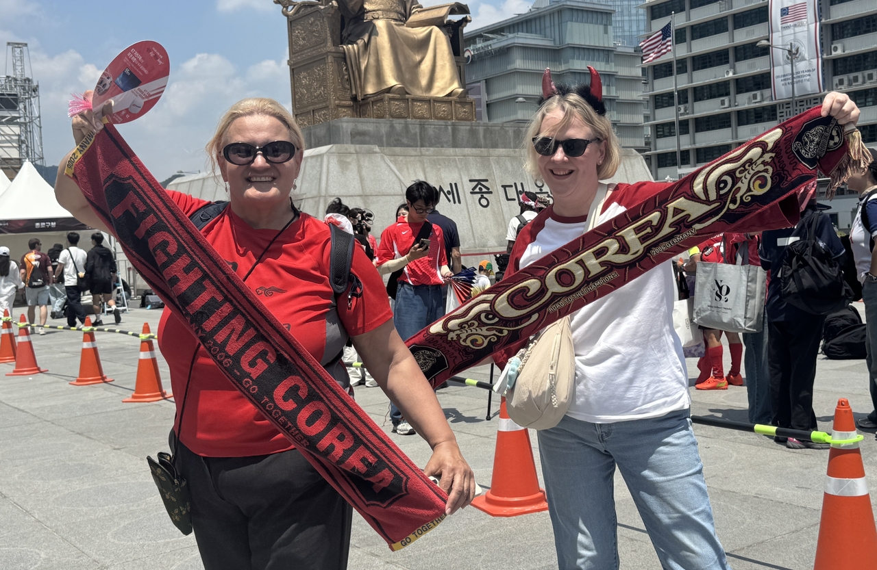 Bianca Turalija from Canada and Rosemary Duncan from South Africa are seen in Gwanghwamun Square, rooting for Team Korea in the 2026 World Cup. (Cha Min-jung/The Korea Herald)