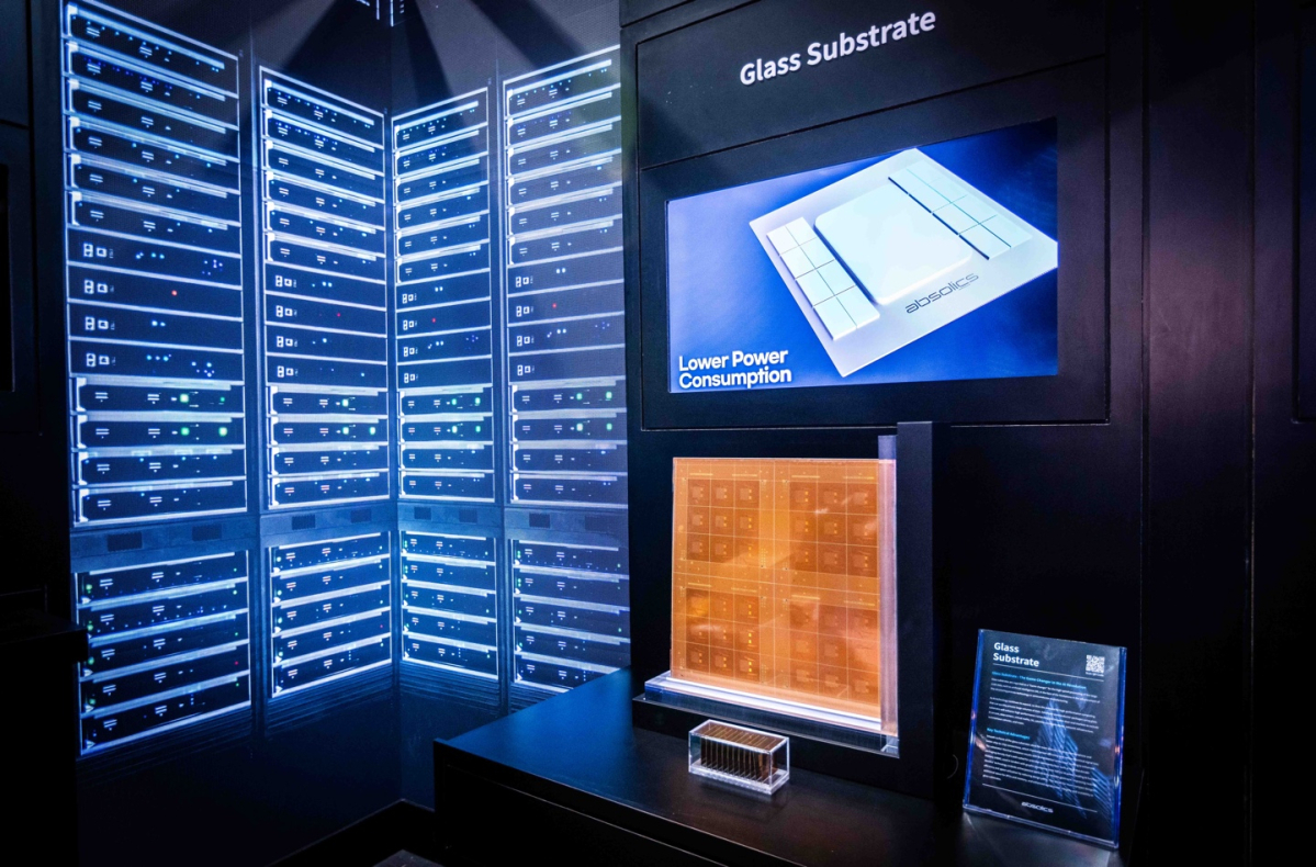 SKC displays its Absolics glass substrate in an AI data-center exhibit at CES 2025 in Las Vegas, presenting the technology as a thinner, lower-power packaging platform for high-performance chips. (SKC)