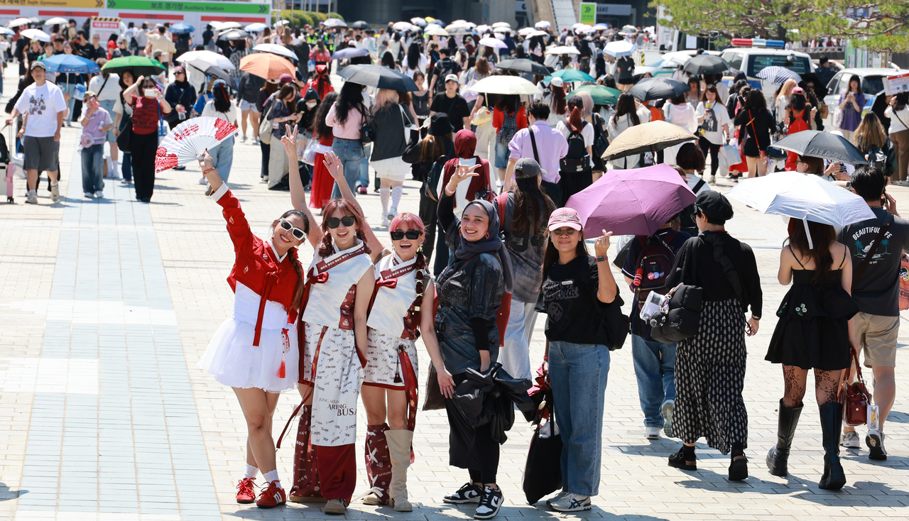 BTS fans pose for photos at Busan Asiad Main Stadium, where the Busan leg of BTS'