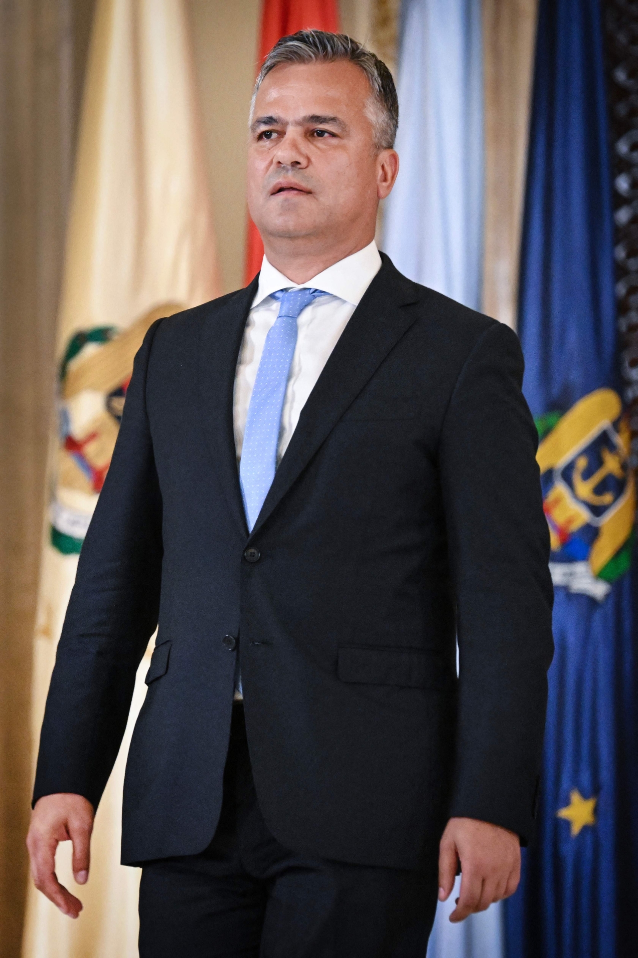 This photograph taken on June 15, 2023 shows the newly designated Romanian Prime Minister, Adrian Vestea, during a swearing-in ceremony as then Minister of Development, Public Works, and Administration at the Cotroceni Palace in Bucharest. Romania's President nominated on June 14, 2026 the 52-year-old liberal politician and former head of the Brasov County Council to lead the government following the withdrawal of previous nominee. Vestea, leader of the Liberal party, has 10 days to form a new cabinet and seek a vote of confidence in parliament to end a month-long political crisis that has threatened the country's access to EU funds and national economic stability. (Photo by Daniel MIHAILESCU / AFP)