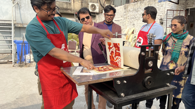 Shakil Mridha (left) works with a press to create printed art, in Dhaka, Bangladesh.    (Daily Star)