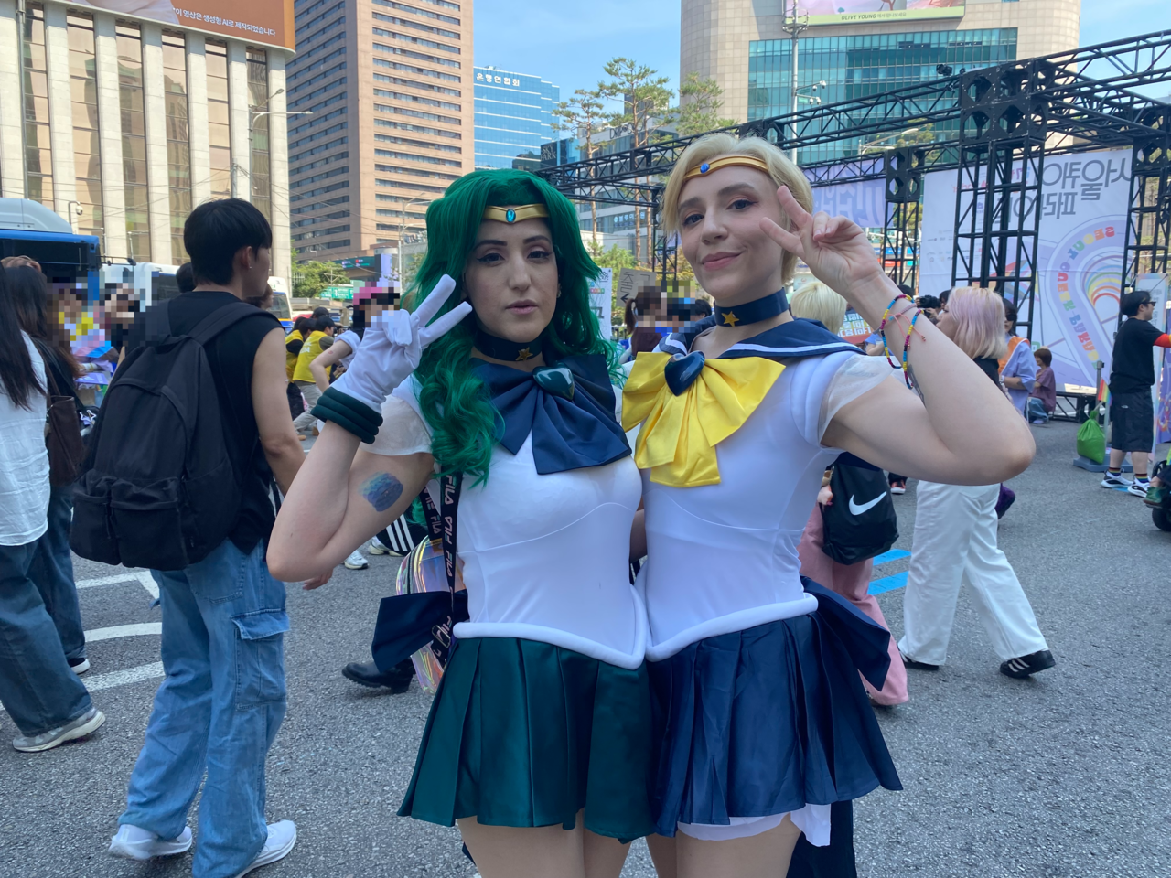 Six (left), 33, and Twin, 32, pose at the 2026 Seoul Queer Parade in central Seoul on Saturday dressed as characters from "Sailor Moon." (Lim Jae-seong/The Korea Herald)
