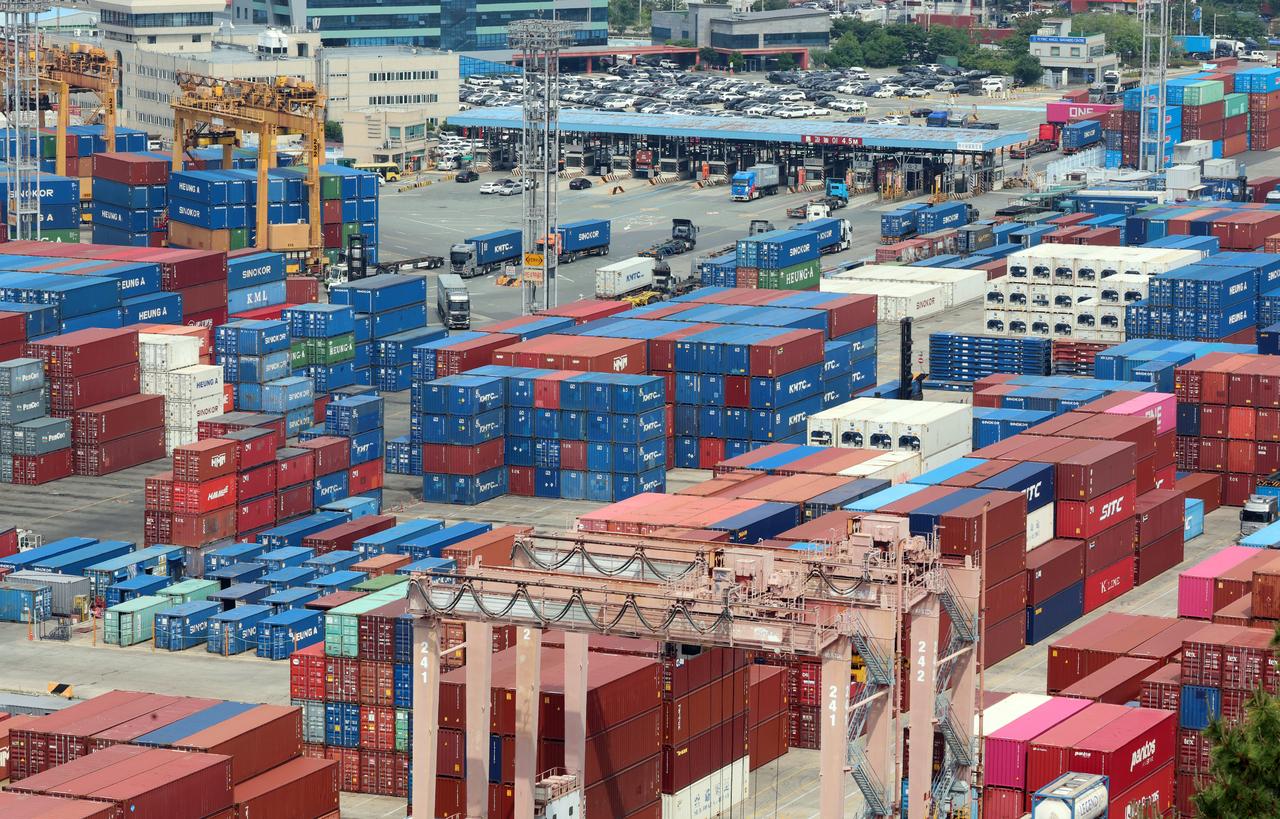 Containers are stacked at a port in the southeastern city of Busan, in this file photo from June 1. (Yonhap)