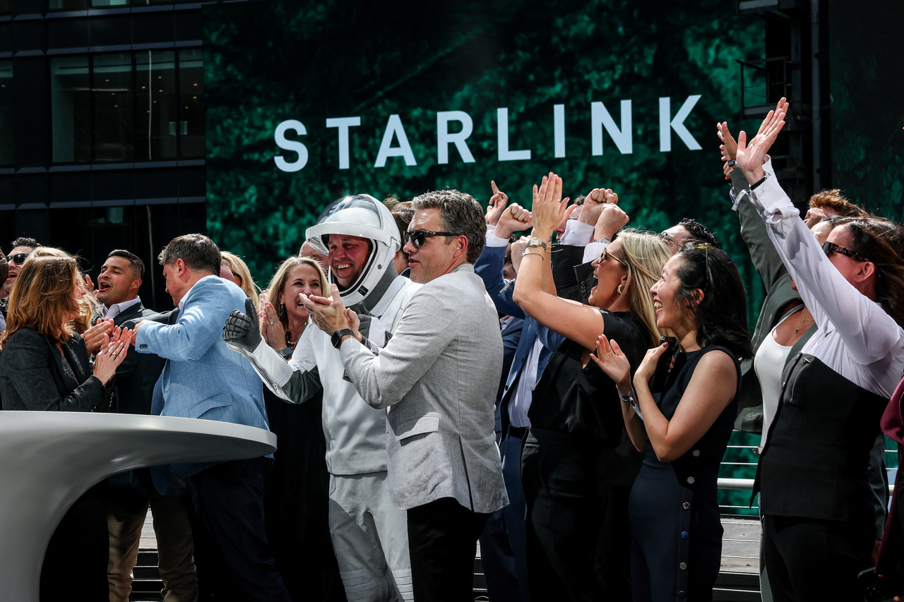 SpaceX leadership and guests celebrate on a balcony at Nasdaq MarketSite on the day of SpaceX's initial public offering in New York, Friday. (Reuters)