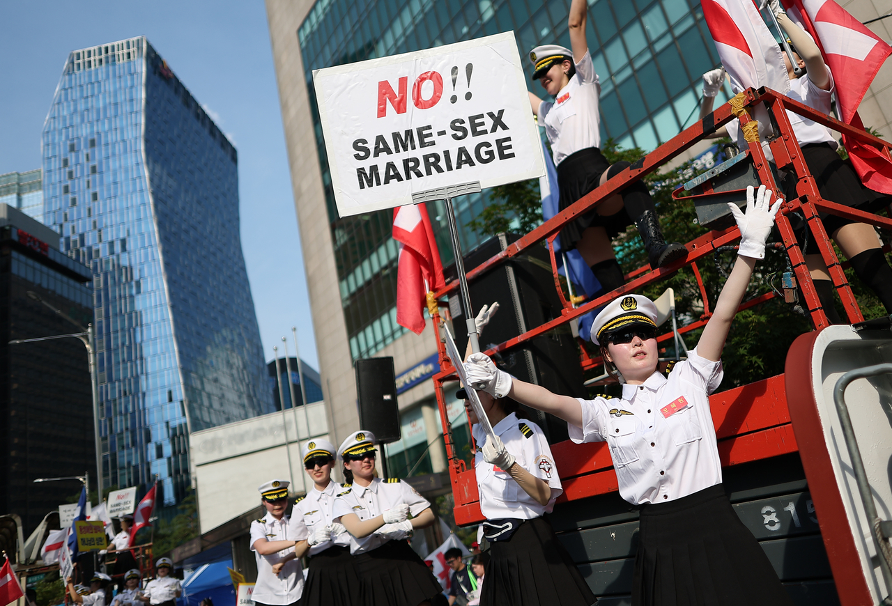 Members of conservative Christian groups protest the 2026 Seoul Queer Parade across the street from the event's main entrance in central Seoul on Saturday. (Yonhap)