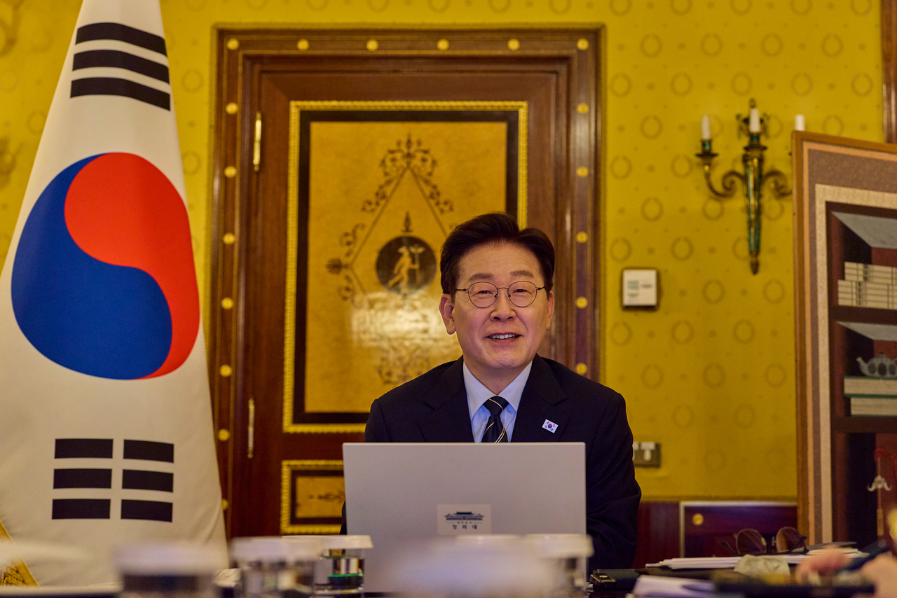 President Lee Jae Myung, who is visiting Italy and the Vatican, speaks during a senior aides’ meeting held via video link from a hotel in Rome on Sunday. (Yonhap)