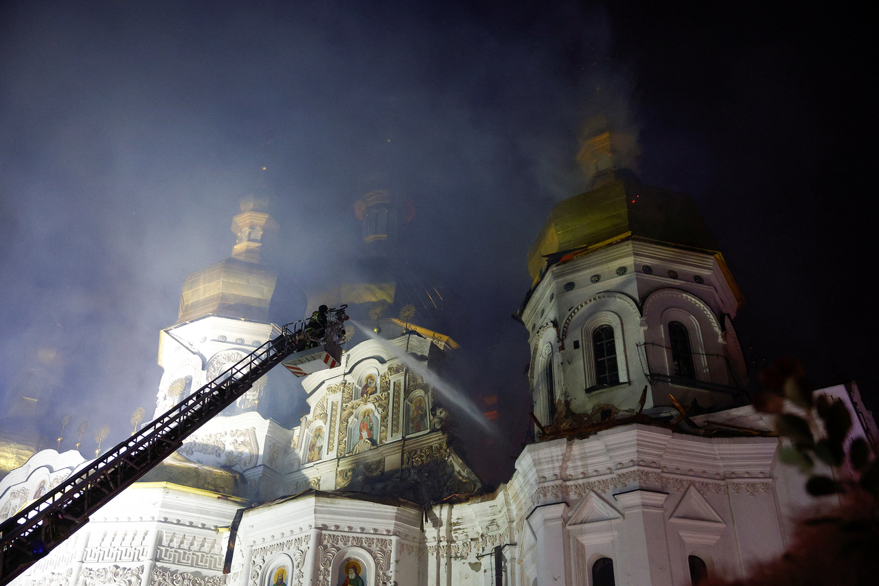 A firefighter works to extinguish a fire at the Dormition Cathedral of the Kyiv-Pechersk Lavra, after it was hit during Russian missile and drone strikes, amid Russia's attack on Ukraine, in Kyiv, Monday. (Reuters-Yonhap)