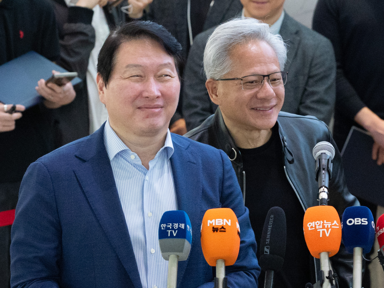 Nvidia CEO Jensen Huang and SK Group Chairman Chey Tae-won speak to reporters at SK’s headquarters in central Seoul on Monday after announcing broader cooperation on memory and AI infrastructure. (Yoon Chang-bin/The Korea Herald)